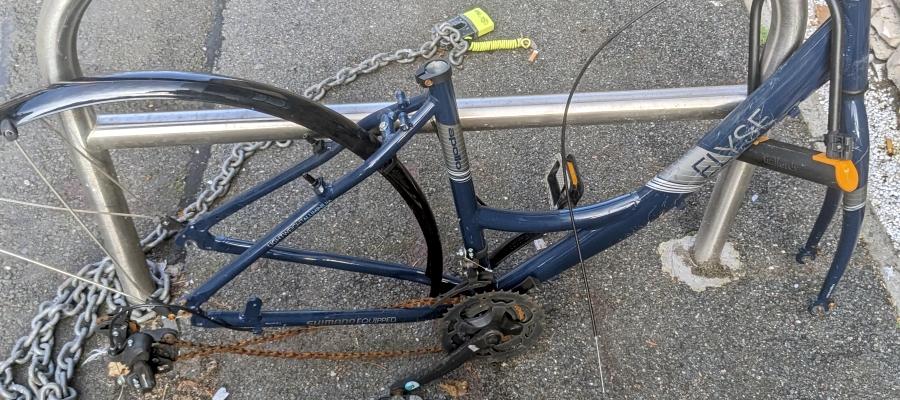 an abandoned bike tied to a railing